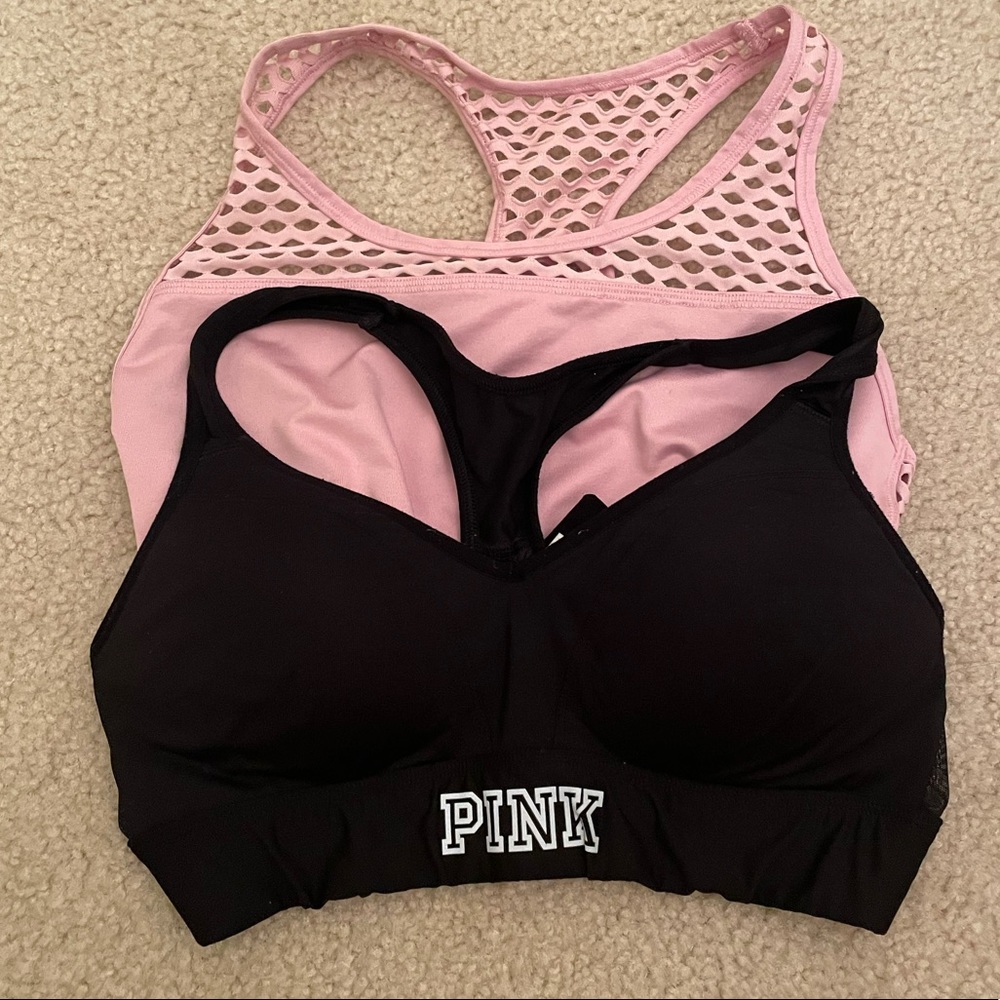 Two pink Victoria’s Secret sports bras